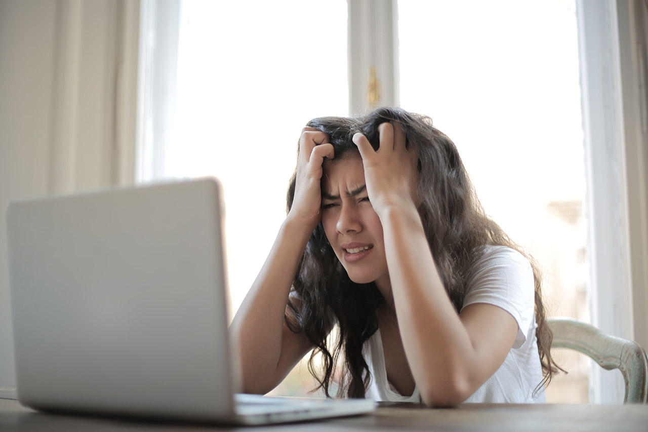 a frustrated person staring at computer screen